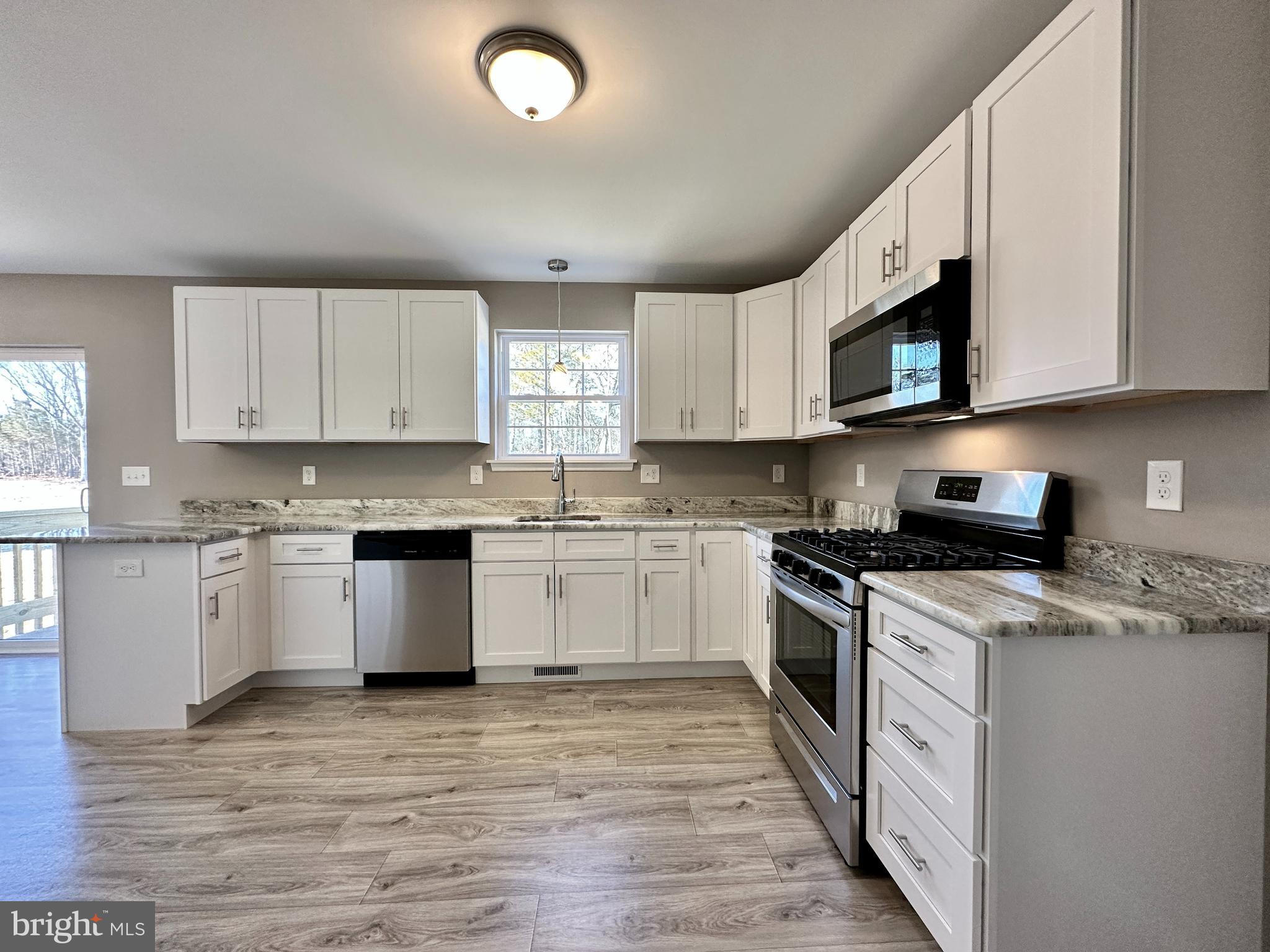 108 West Park Avenue Vineland, NJ 08360 - Photo 16 of 37 a kitchen with stainless steel appliances granite countertop a stove a sink and a microwave