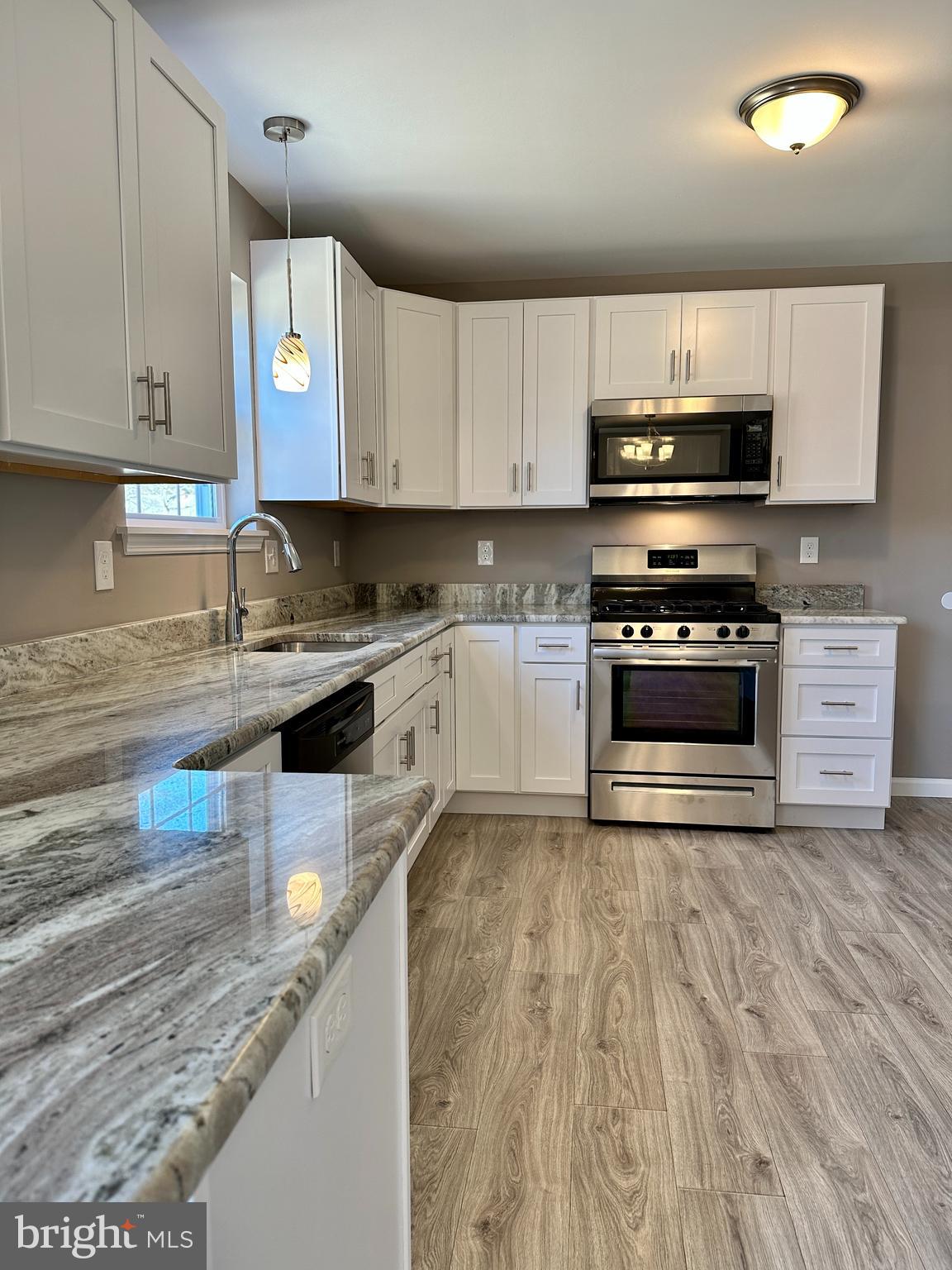 108 West Park Avenue Vineland, NJ 08360 - Photo 17 of 37 a kitchen with stainless steel appliances granite countertop a stove a sink and a microwave