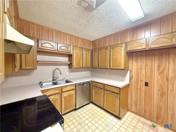 a kitchen with a sink cabinets and appliances