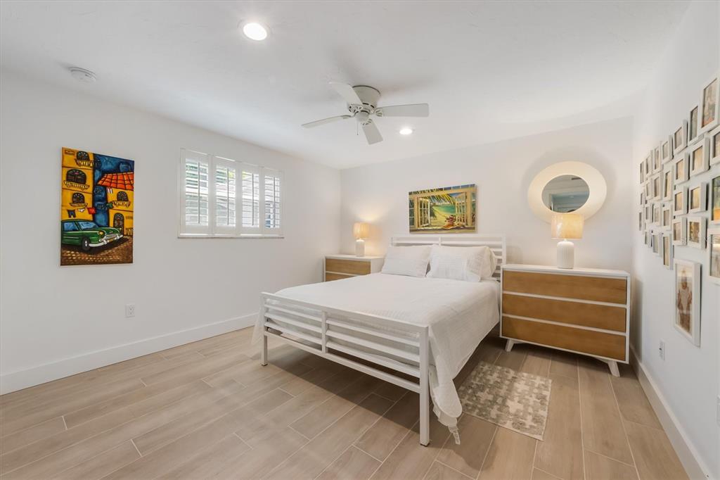 413 Poinsettia Road Anna Maria, FL 34216 - Photo 21 of 60 a bedroom with a bed and a chandelier