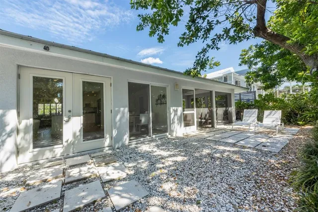 an aerial view of a residential houses with outdoor space and lake view