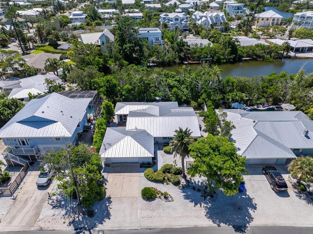413 Poinsettia Road Anna Maria, FL 34216 - Photo 45 of 60 an aerial view of a house with a yard and lake view