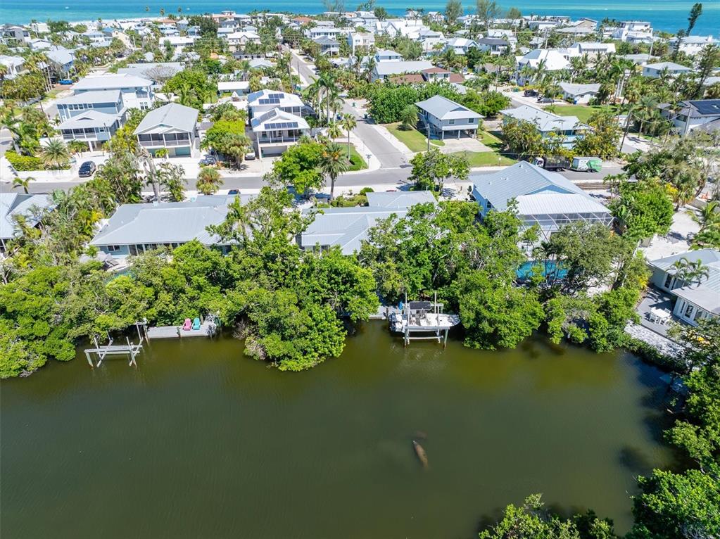 413 Poinsettia Road Anna Maria, FL 34216 - Photo 46 of 60 an aerial view of residential houses with outdoor space and lake view