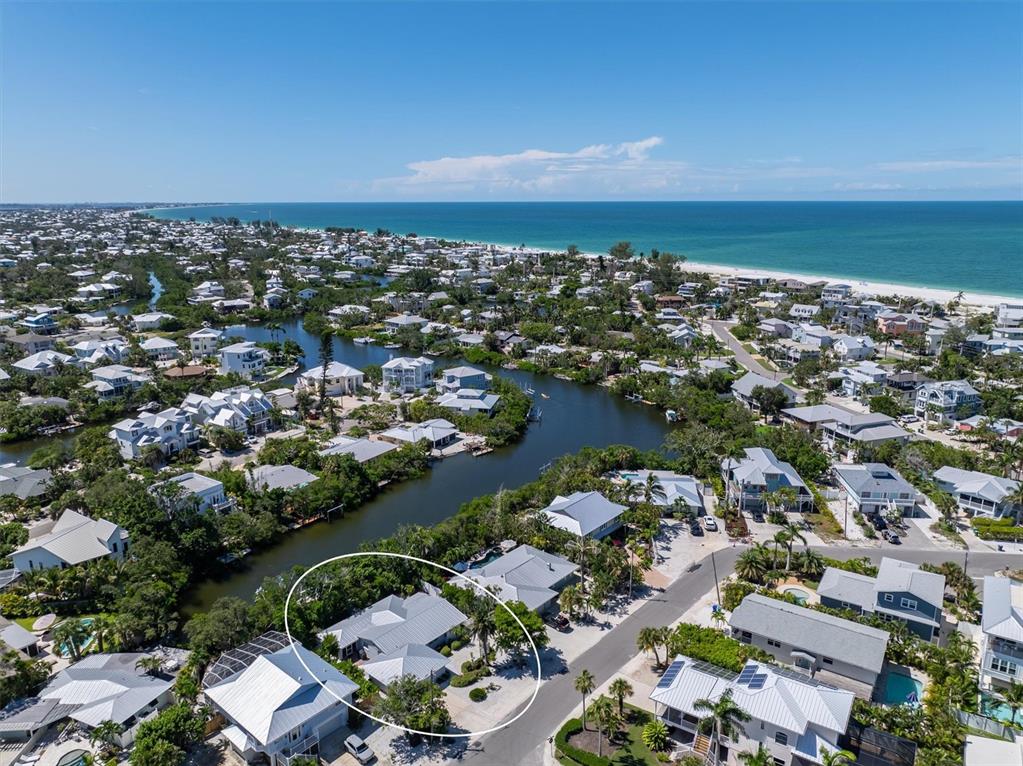 413 Poinsettia Road Anna Maria, FL 34216 - Photo 49 of 60 an aerial view of a city with lots of residential buildings and ocean view in back