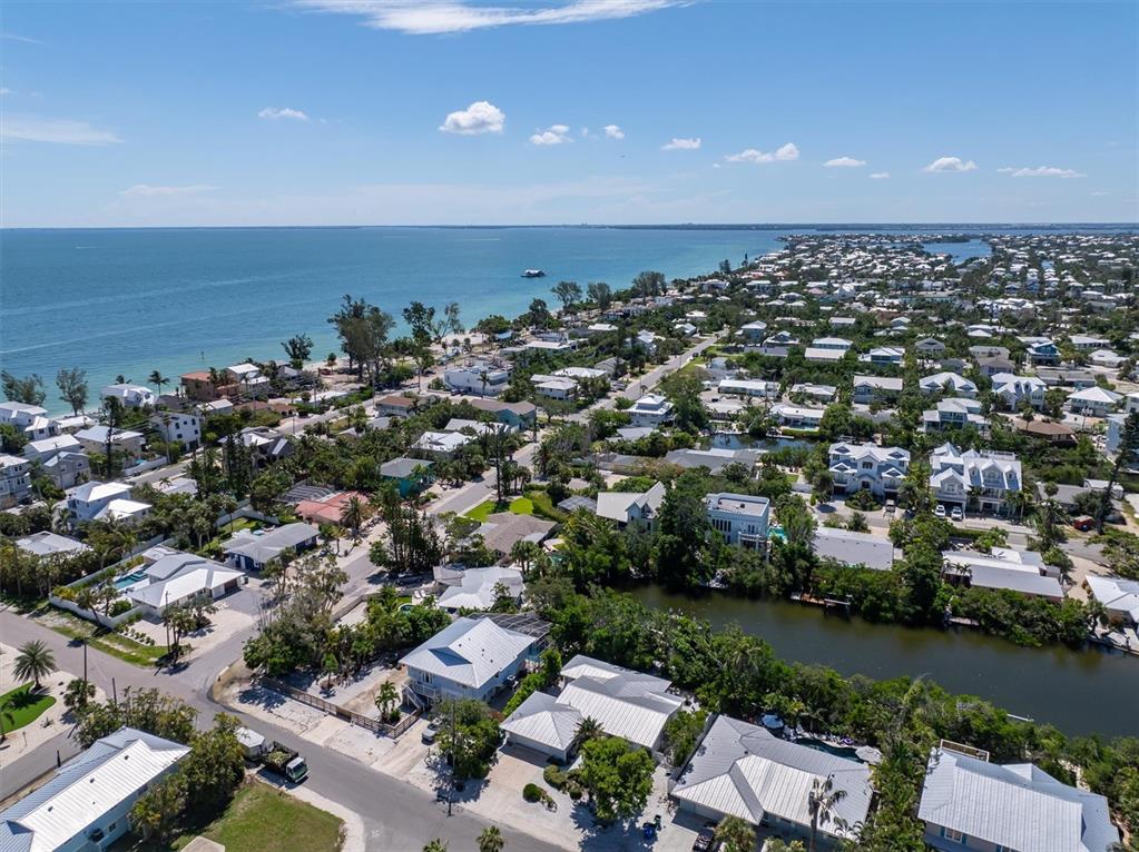 413 Poinsettia Road Anna Maria, FL 34216 - Photo 50 of 60 an aerial view of a city with lots of residential buildings and lake view in back