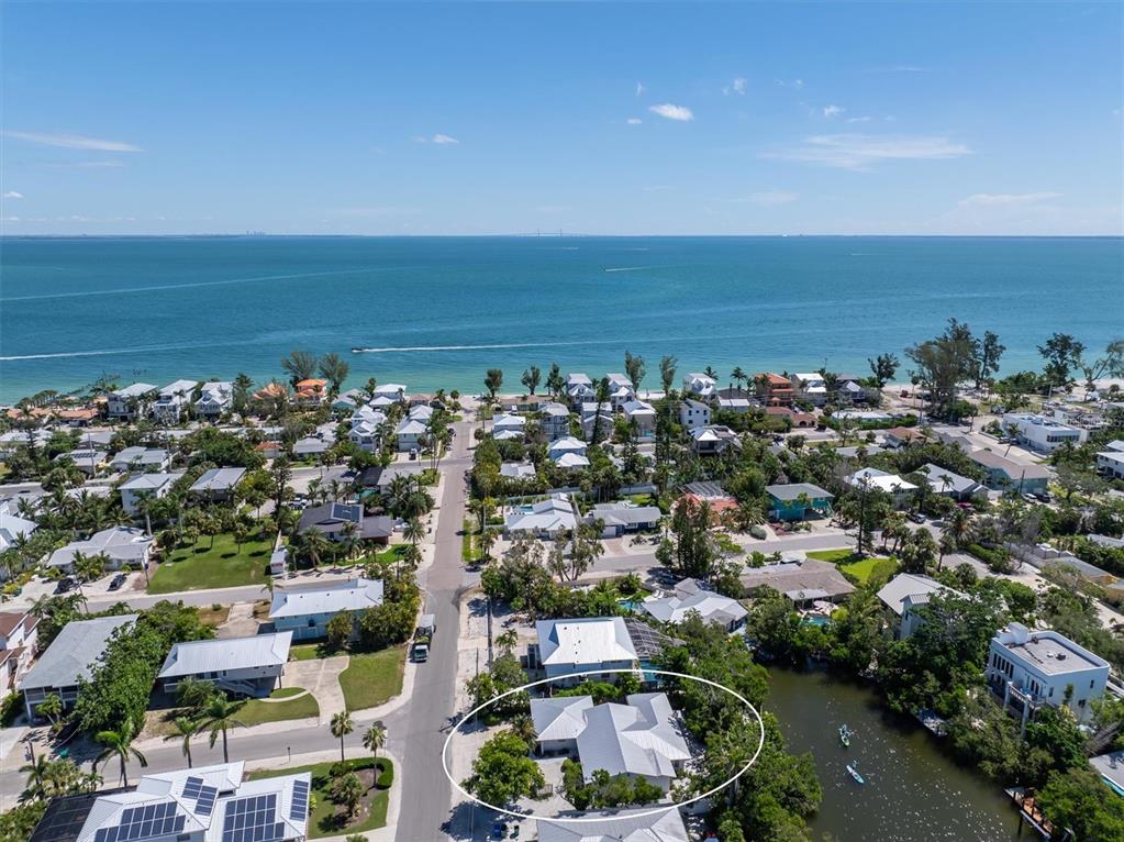413 Poinsettia Road Anna Maria, FL 34216 - Photo 51 of 60 an aerial view of a city with lots of residential buildings and ocean view in back