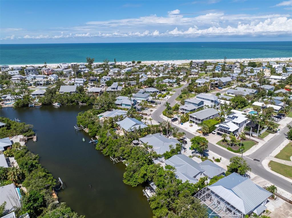 413 Poinsettia Road Anna Maria, FL 34216 - Photo 55 of 60 an aerial view of a residential houses with outdoor space and lake view