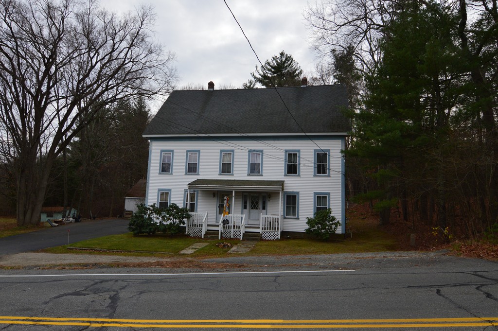222 Whitins Road Sutton, MA 01590 - Photo 1 of 20 a view of white house with a yard and large trees