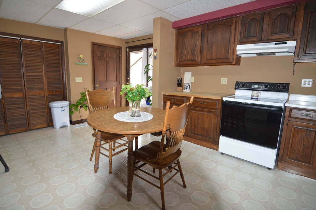 222 Whitins Road Sutton, MA 01590 - Photo 3 of 20 a kitchen with a stove a table and chairs