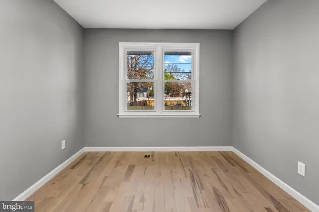 a view of room with window and hardwood floor