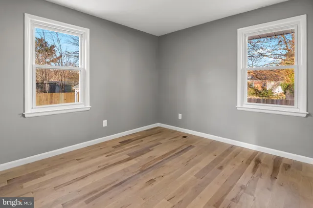 a view of room with window and wooden floor