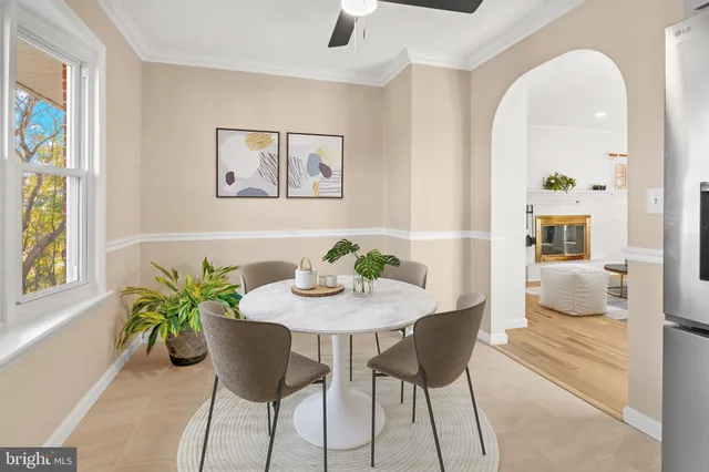 a view of a dining room with furniture and a potted plant