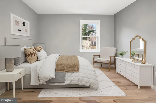 a bedroom with a large bed and a window