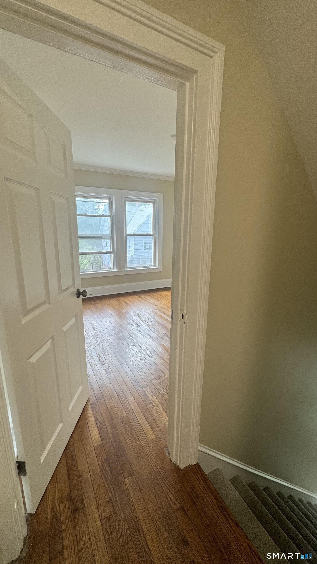 104 Prospect Street Ansonia, CT 06401 - Photo 24 of 40 a view of empty room with wooden floor and fan