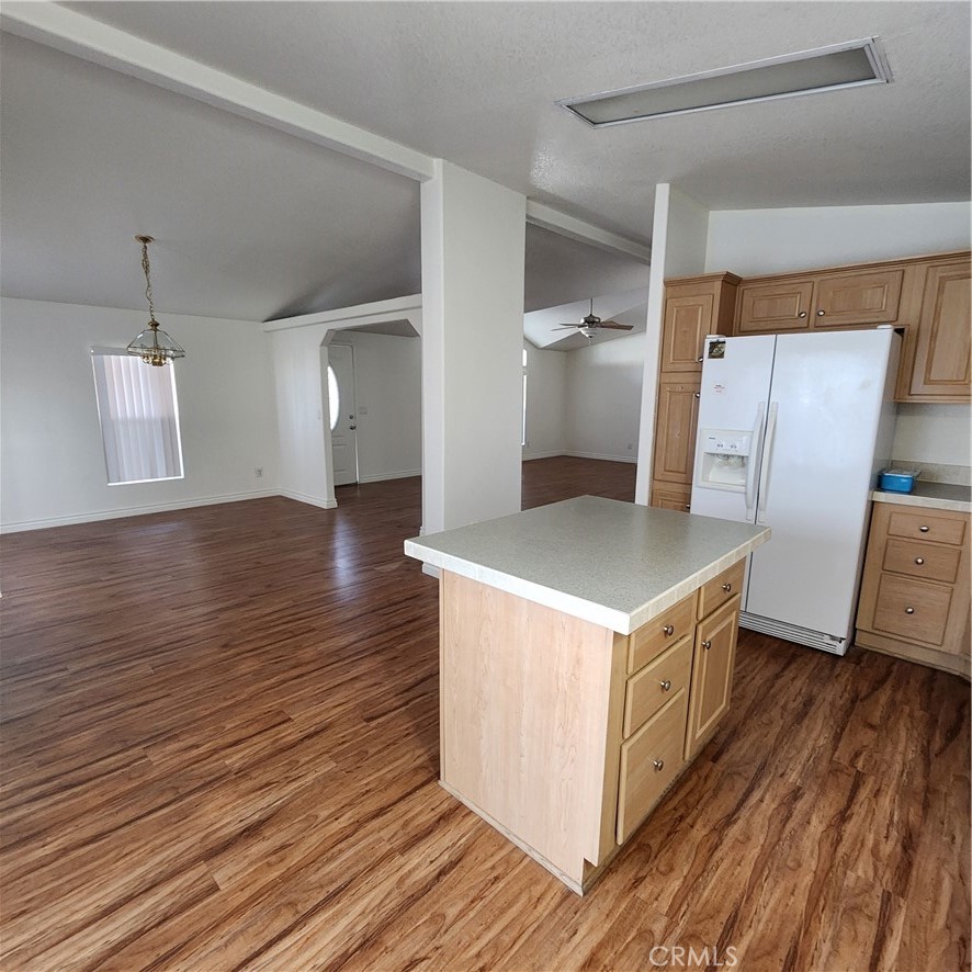 20843 Waalew Road, Unit C136 Apple Valley, CA 92307 - Photo 11 of 39 a kitchen with stainless steel appliances granite countertop a wooden floor a sink and a refrigerator