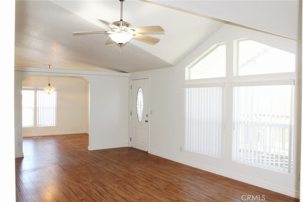 20843 Waalew Road, Unit C136 Apple Valley, CA 92307 - Photo 12 of 39 a view of an empty room with wooden floor and a window