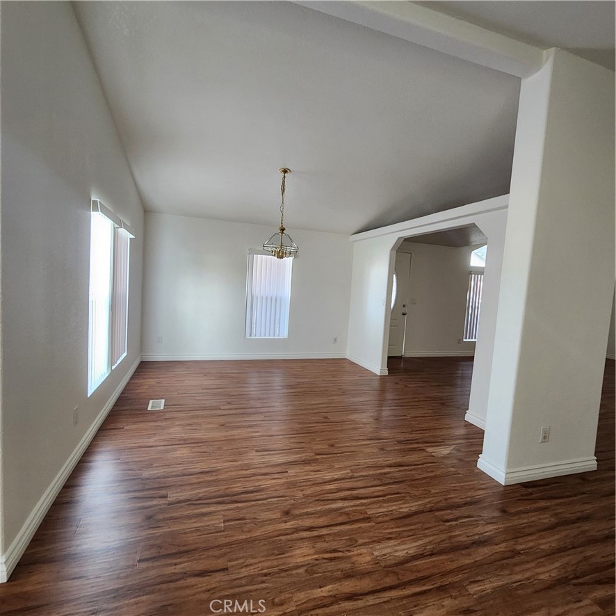 20843 Waalew Road, Unit C136 Apple Valley, CA 92307 - Photo 13 of 39 a view of an empty room with wooden floor and a window