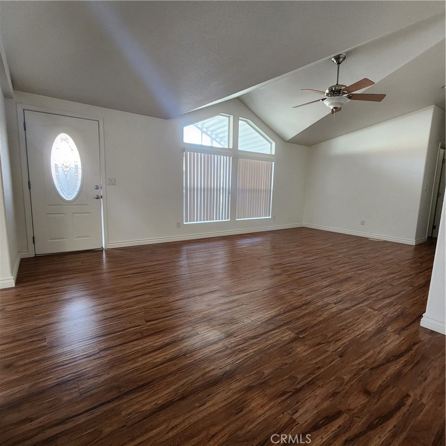 20843 Waalew Road, Unit C136 Apple Valley, CA 92307 - Photo 15 of 39 an empty room with wooden floor fan and windows