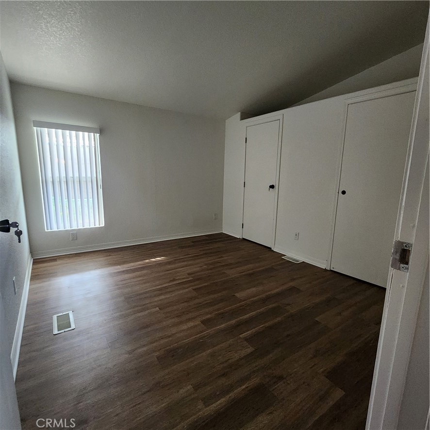 20843 Waalew Road, Unit C136 Apple Valley, CA 92307 - Photo 20 of 39 an empty room with wooden floor and windows