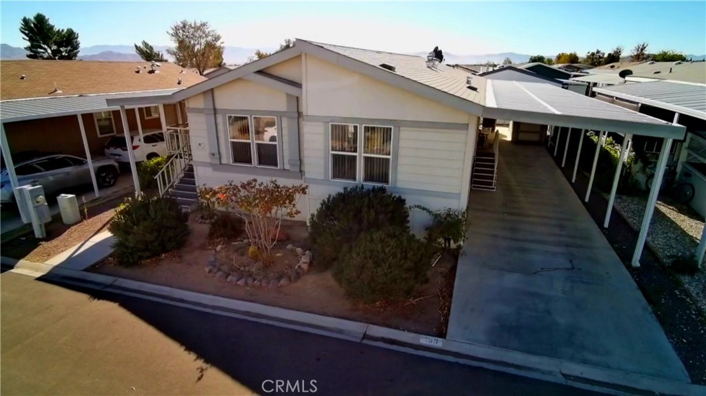 20843 Waalew Road, Unit C136 Apple Valley, CA 92307 - Photo 2 of 39 a view of a house with backyard and sitting area
