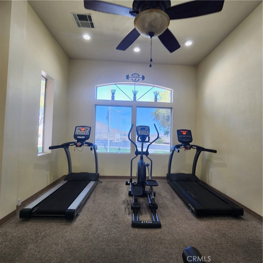 20843 Waalew Road, Unit C136 Apple Valley, CA 92307 - Photo 31 of 39 a room with gym equipment and windows