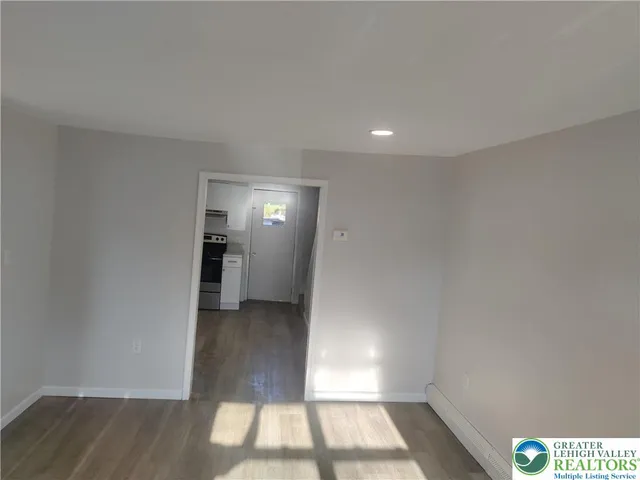 a view of hallway with wooden floor