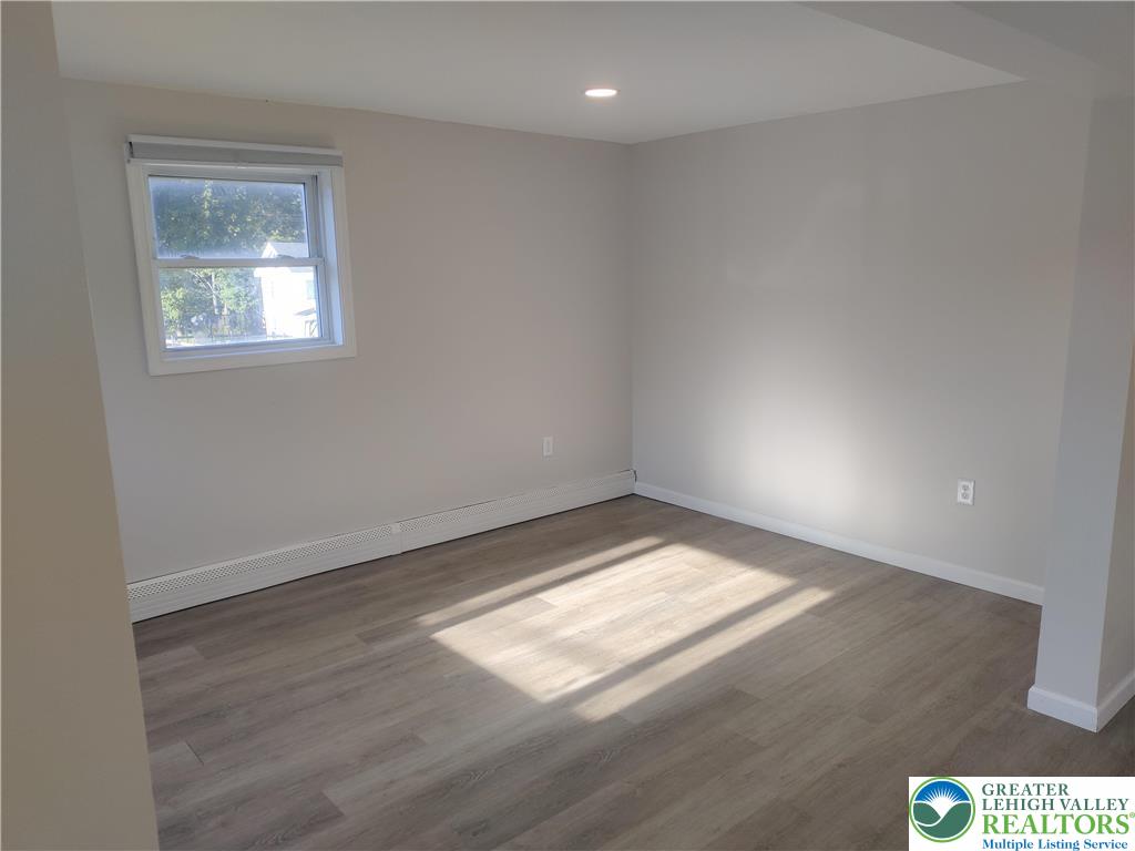 25 Franklin Street Weatherly, PA 18255 - Photo 20 of 40 an empty room with wooden floor and windows