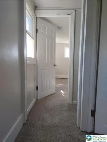 a bathroom with a toilet and a window