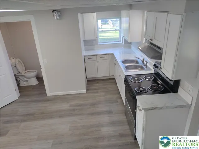a kitchen with a stove and a white cabinet