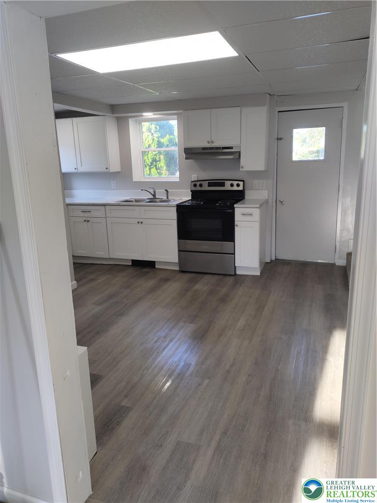 25 Franklin Street Weatherly, PA 18255 - Photo 10 of 40 a kitchen with a white cabinets and wooden floor