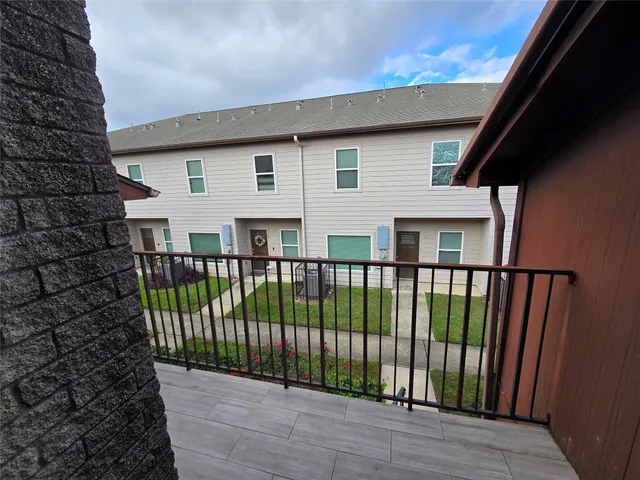 a view of a balcony with wooden floor