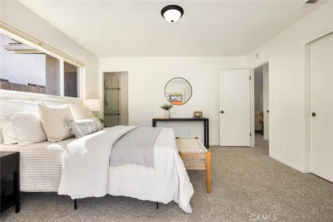 a bathroom with a granite countertop sink mirror vanity and toilet
