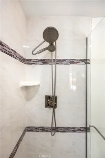 a bedroom with a bed a lamp and a large window