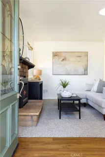 a living room with furniture a fireplace and wall
