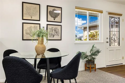 a living room with furniture a clock and a fireplace