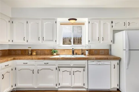 a kitchen with cabinets a washer and dryer