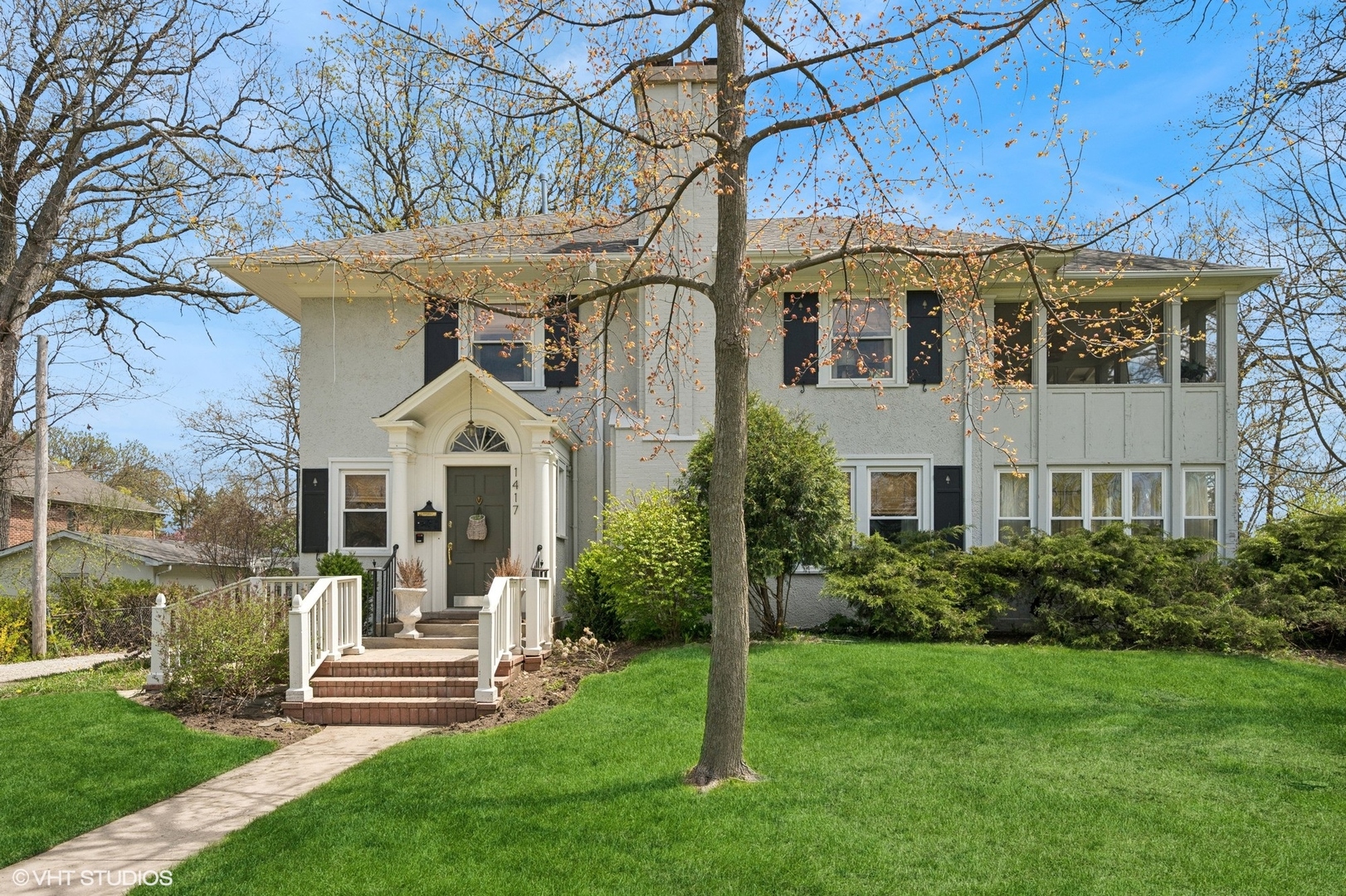 1417 Green Bay Road Highland Park, IL 60035 - Photo 1 of 7 a front view of a house with a garden and plants