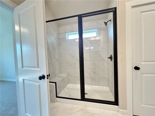 a bathroom with a glass shower door