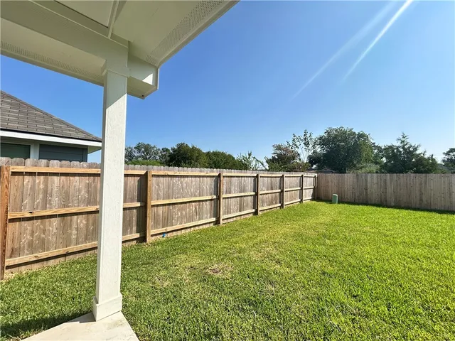 a view of backyard with small cabin