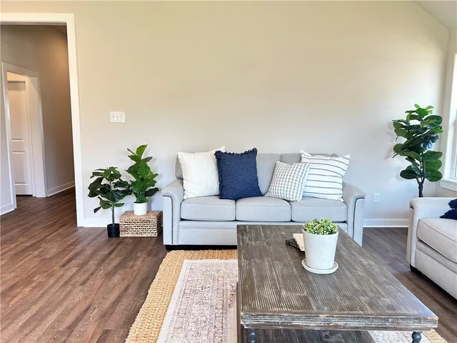 a living room with furniture and a potted plant