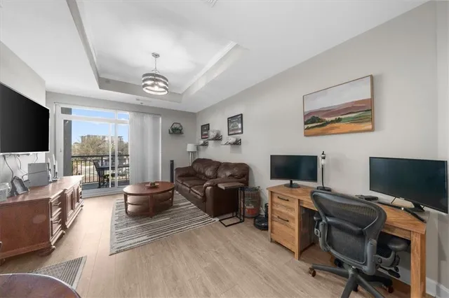 a view of a livingroom with workspace and a couch