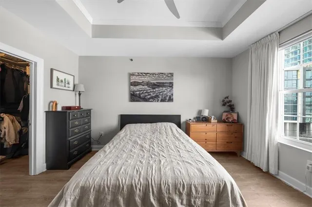 a bedroom with a large bed and a flat tv screen