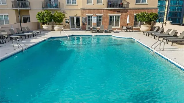 a view of swimming pool with outdoor seating and a patio