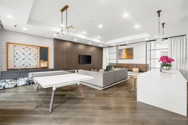 a living room with granite countertop furniture and a flat screen tv