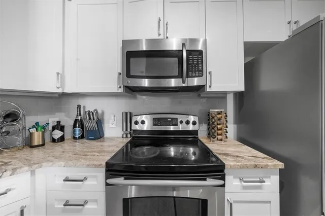 a stove top oven sitting inside of a kitchen