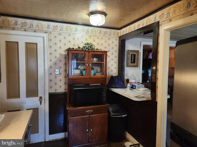 a kitchen with a refrigerator and a stove