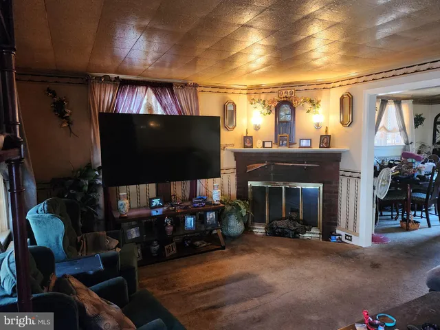 a living room with fireplace furniture and a flat screen tv