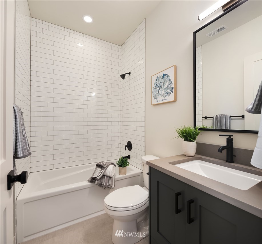 23517 7th Avenue Southeast Bothell, WA 98021 - Photo 20 of 32 a bathroom with a toilet sink and mirror