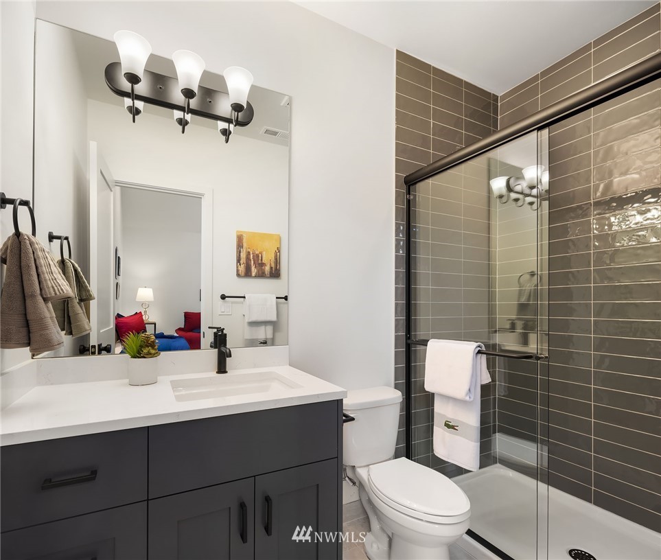 23517 7th Avenue Southeast Bothell, WA 98021 - Photo 23 of 32 a bathroom with a sink mirror toilet and shower
