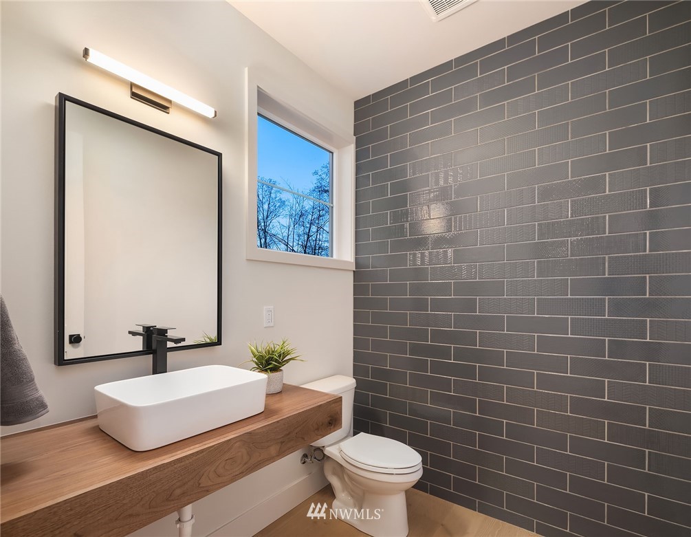 23517 7th Avenue Southeast Bothell, WA 98021 - Photo 26 of 32 a bathroom with a sink a toilet and mirror